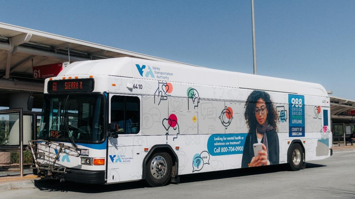 bus wrapped in 988 ad