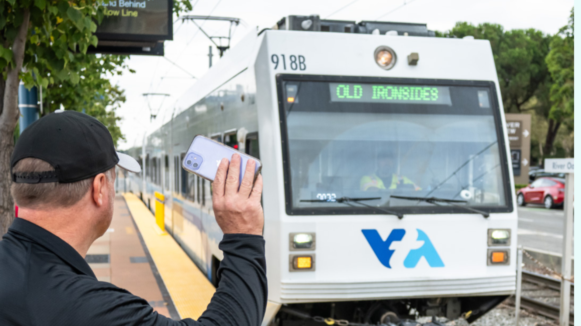 Rider waving at light rail train