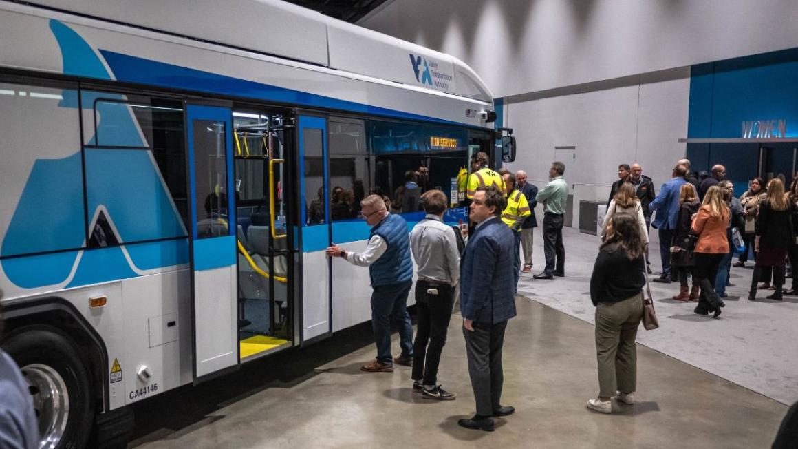 Conference attendees looking at VTA bus