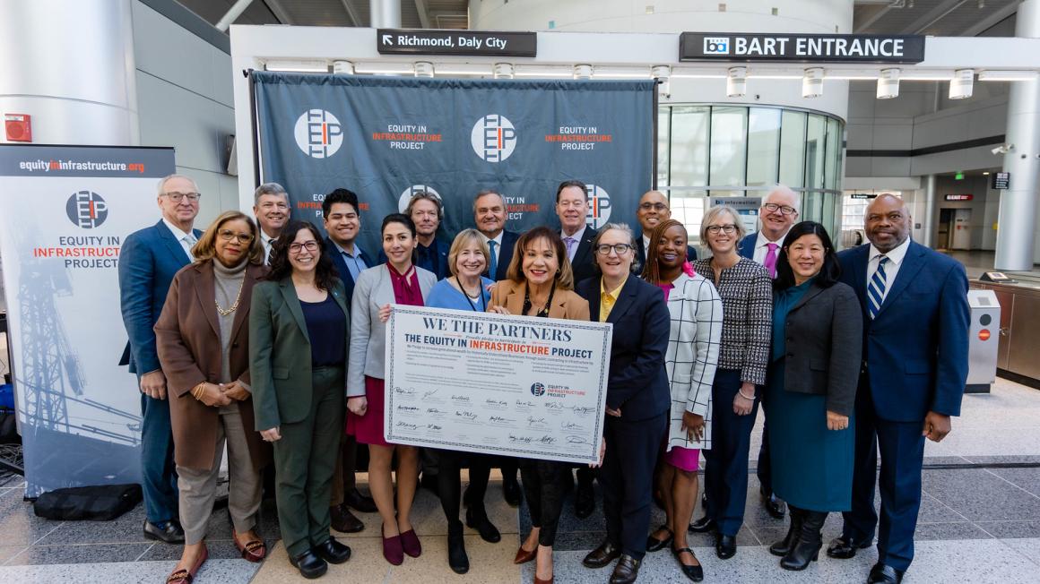 group shot of transit agency CEOs with pledge board