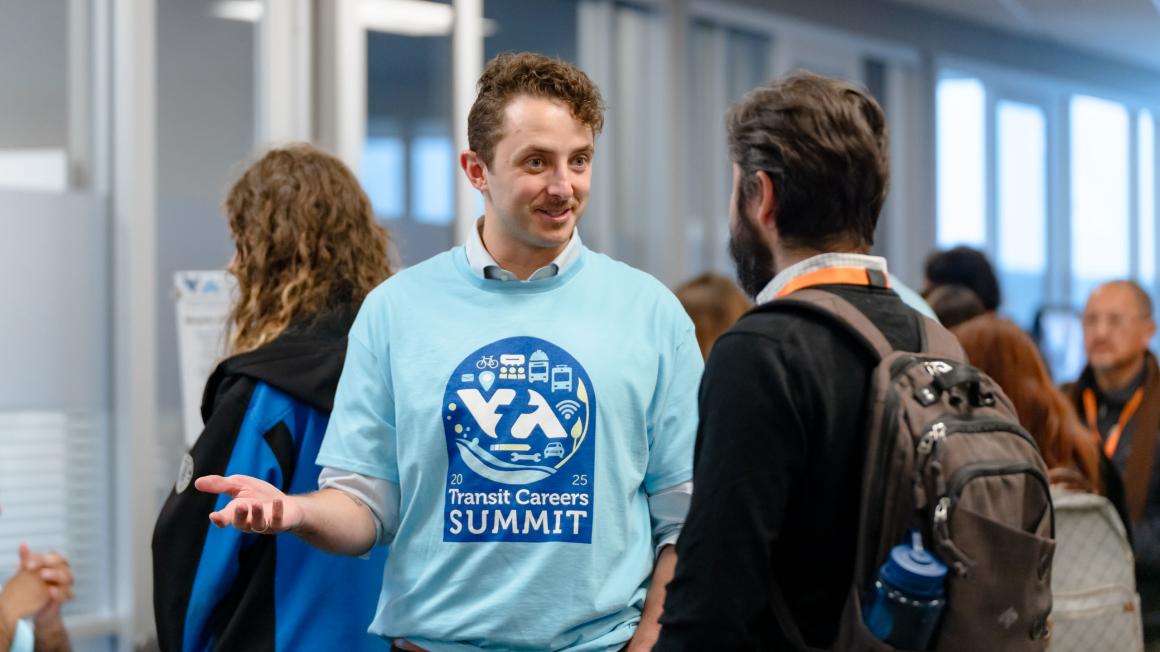 VTA staff talking to an attendee at the summit