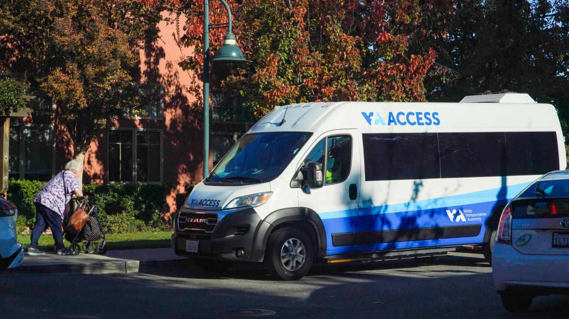 VTA access paratransit van; woman walking toward it with walker