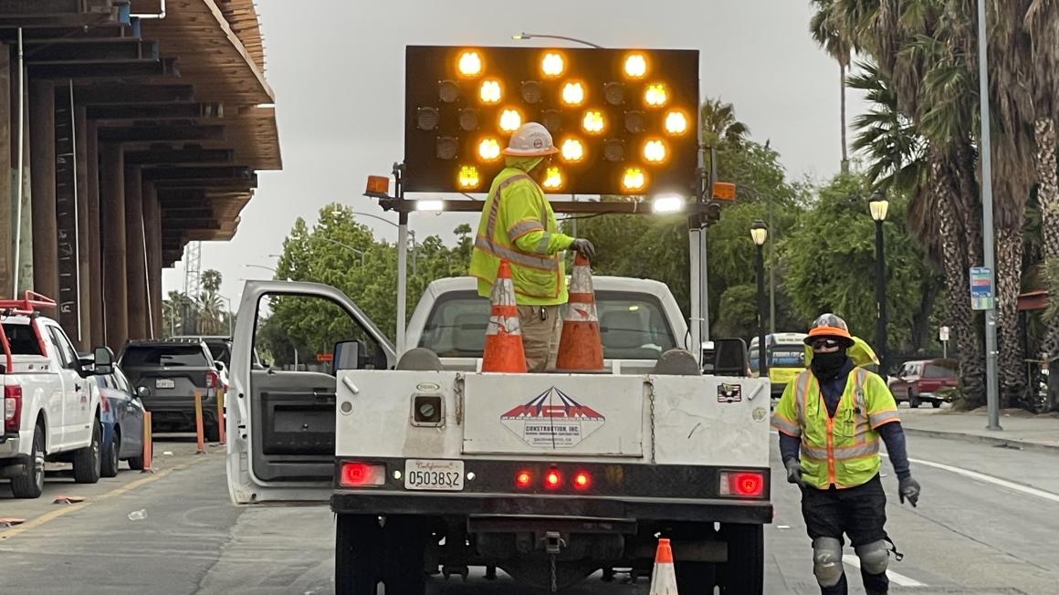construction worker and truck in street