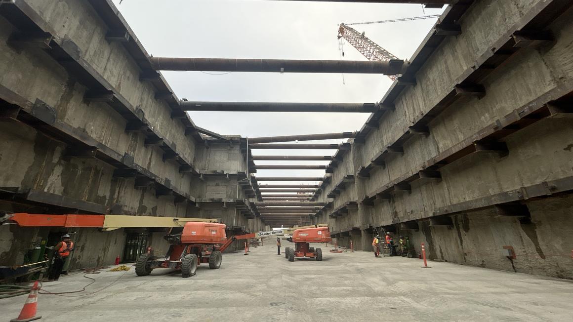 launch shaft for tunnel boring maching with trucks and workers