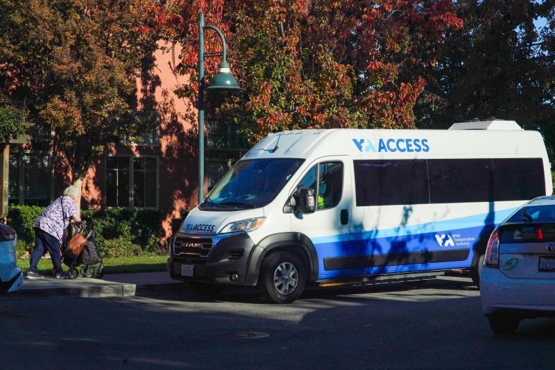 VTA access paratransit van; woman walking toward it with walker