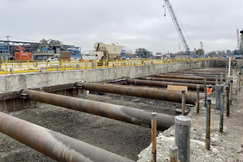 metal pipes across a wide ditch in the ground