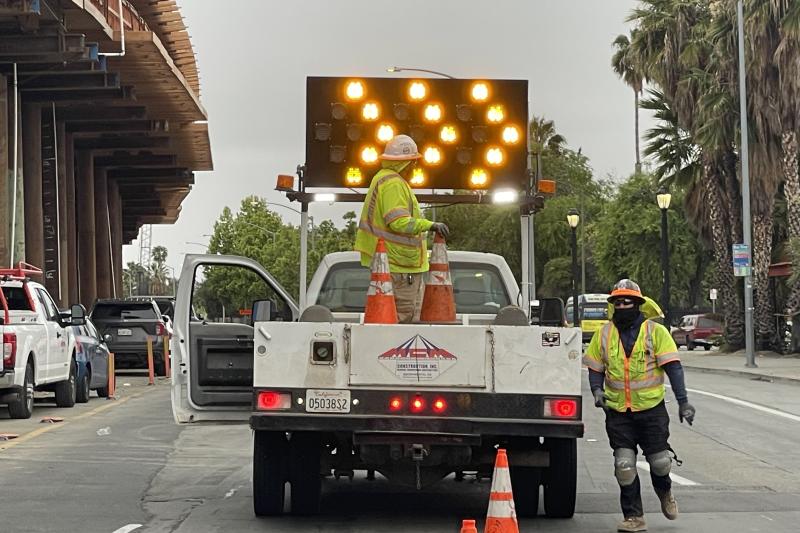 construction worker and truck in street