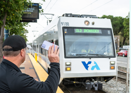 Rider waving at light rail train