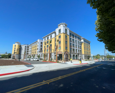 blue sky backdrop and new yellow and white apartment building