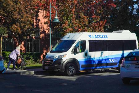VTA access paratransit van; woman walking toward it with walker