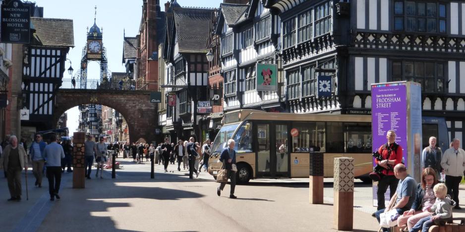 A photo of a commercial center with people walking and sitting.