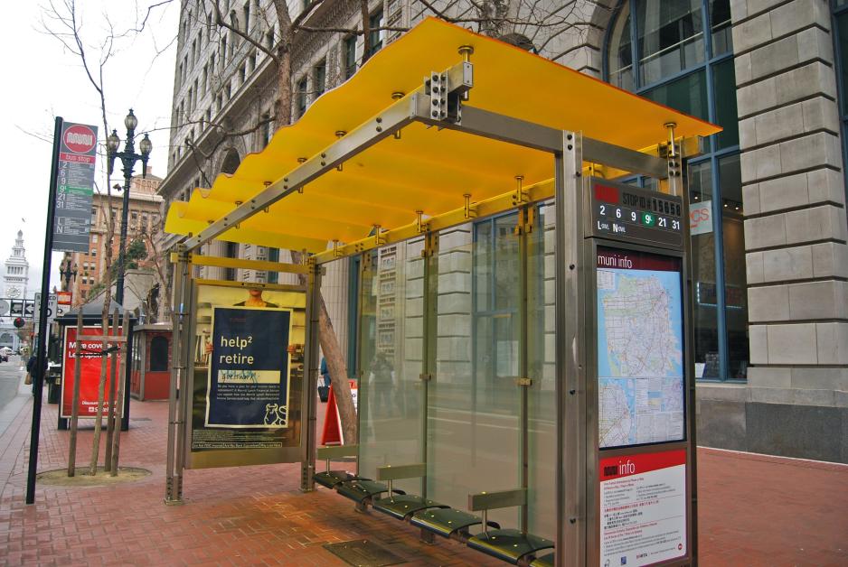 S1C4.5G8Muni-Shelter-SergioRuiz.jpg A photo of a bus shelter near commercial buildings.