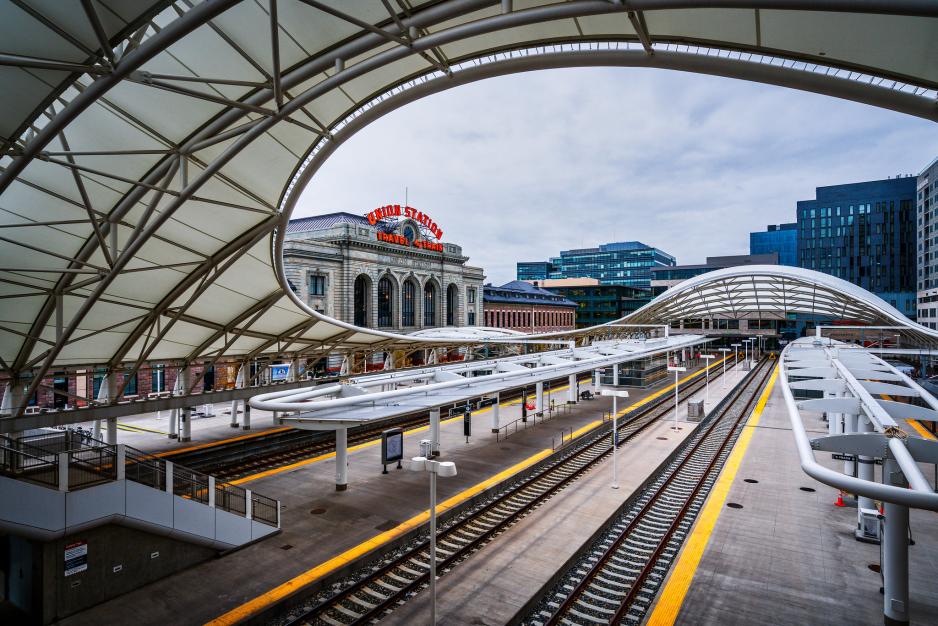 S2.6C6.5G1_DenverUnionStation-Flickr-MobilusInMobili_0.jpg A photo of an elevated train track with office buildings in the distance.