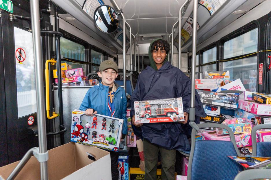 Children holding toys inside a VTA bus