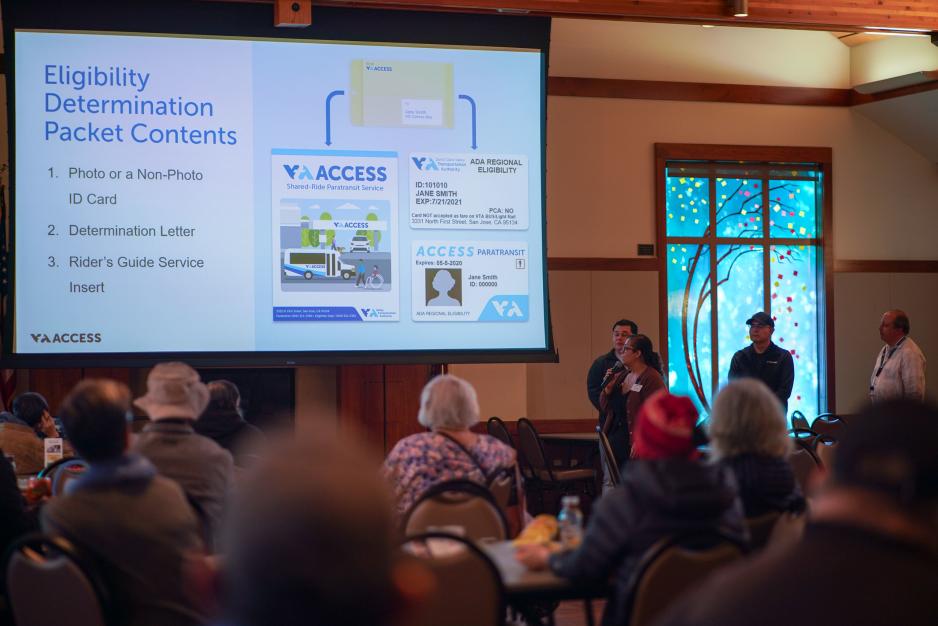 meeting participants listen to speaker, watch slide presentation