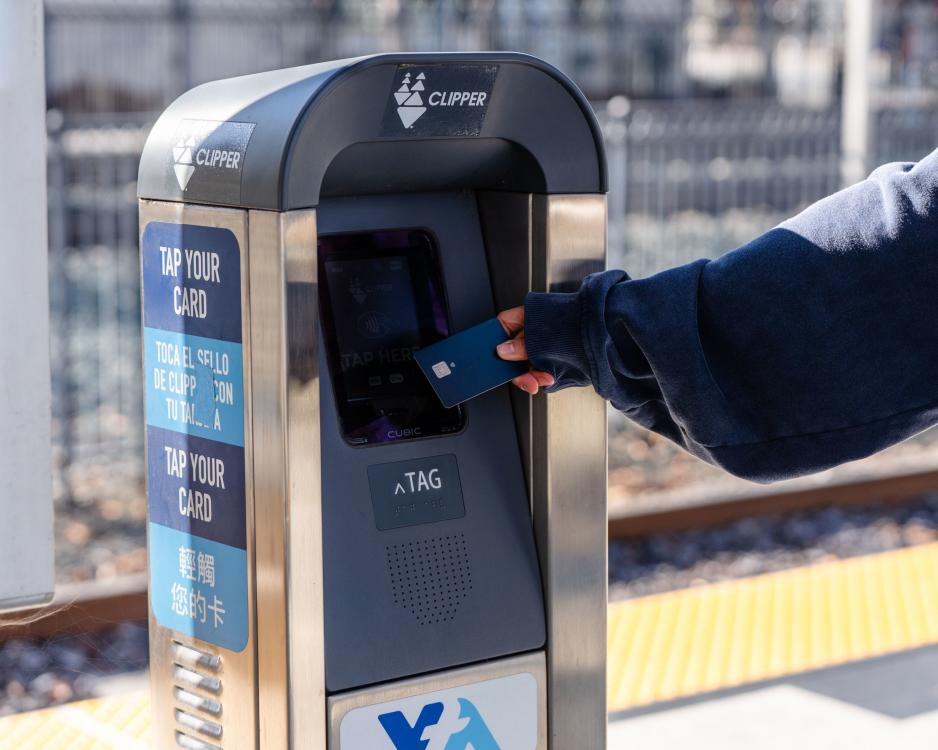 image shows a person using a bank card on a clipper machine