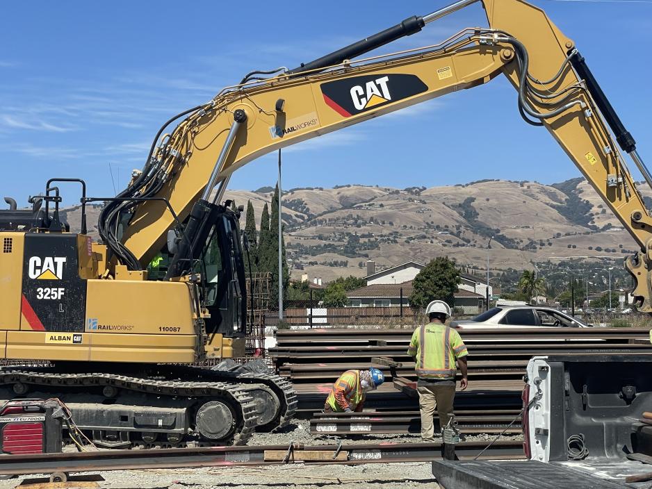 men working by an excavator