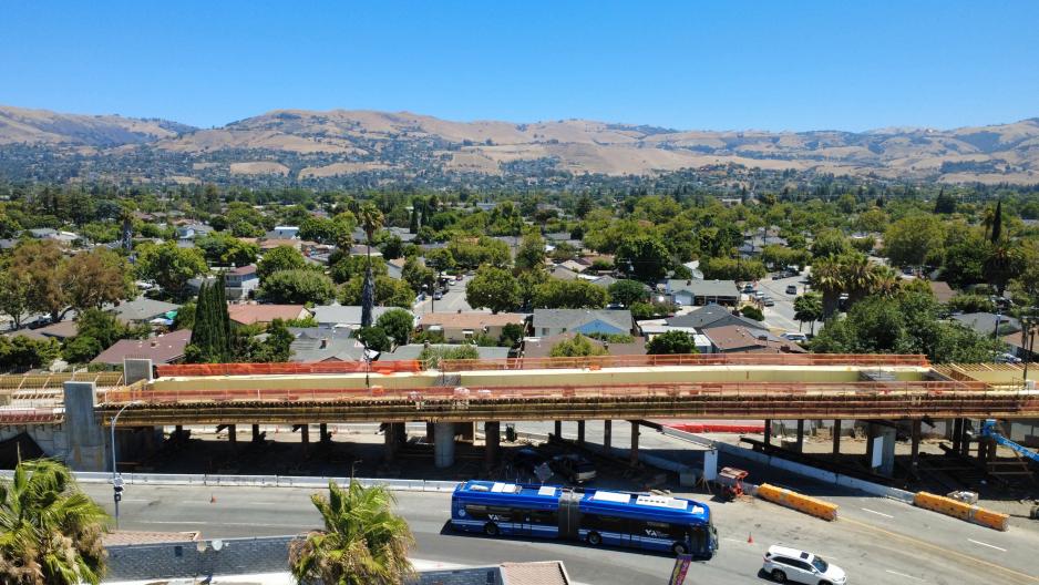 Aerial view of East San Jose, a bridge in construction, and a VTA bus