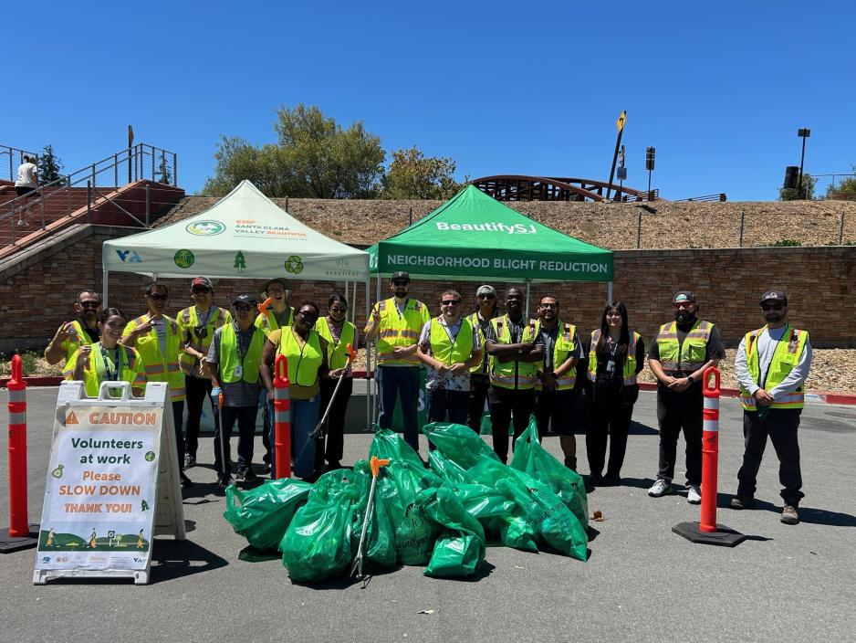a group of people posing after picking up trash from the freeway