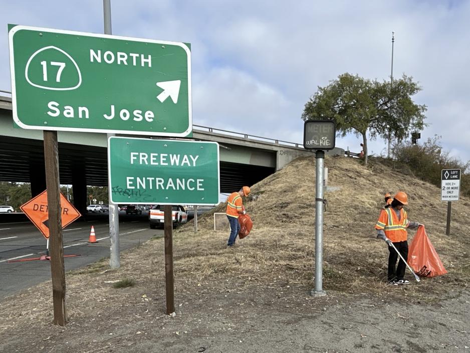 people picking up trash on the freeway