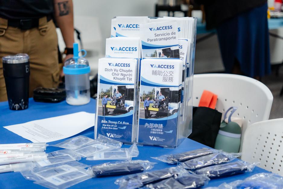 VTA ACCESS paratransit brochures in multiple languages are displayed alongside informational materials and giveaways at the Coffee with the Community event.